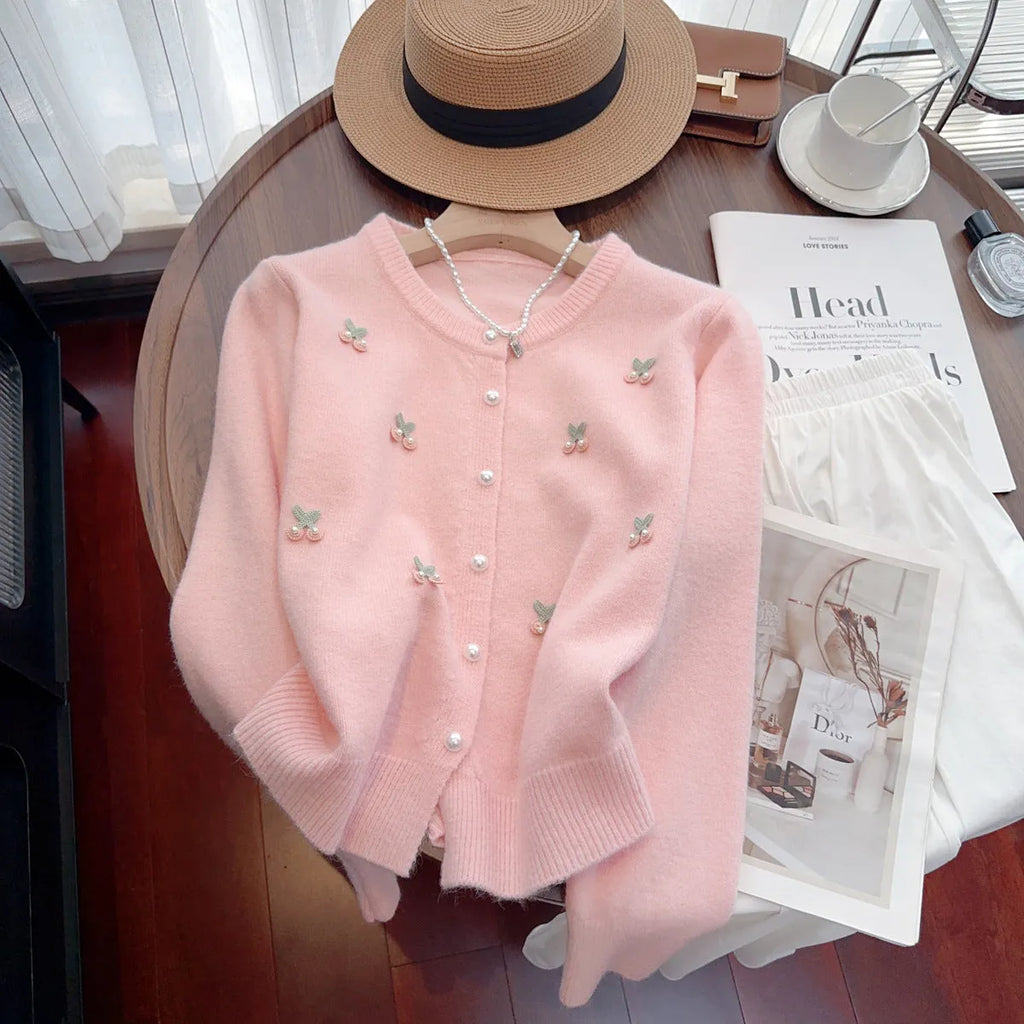 Blue cashmere blend round neck cardigan coat with beaded detail on a hanger.