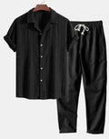 Men's camouflage print casual suit set with short-sleeve lapel shirt and trousers on a hanger.