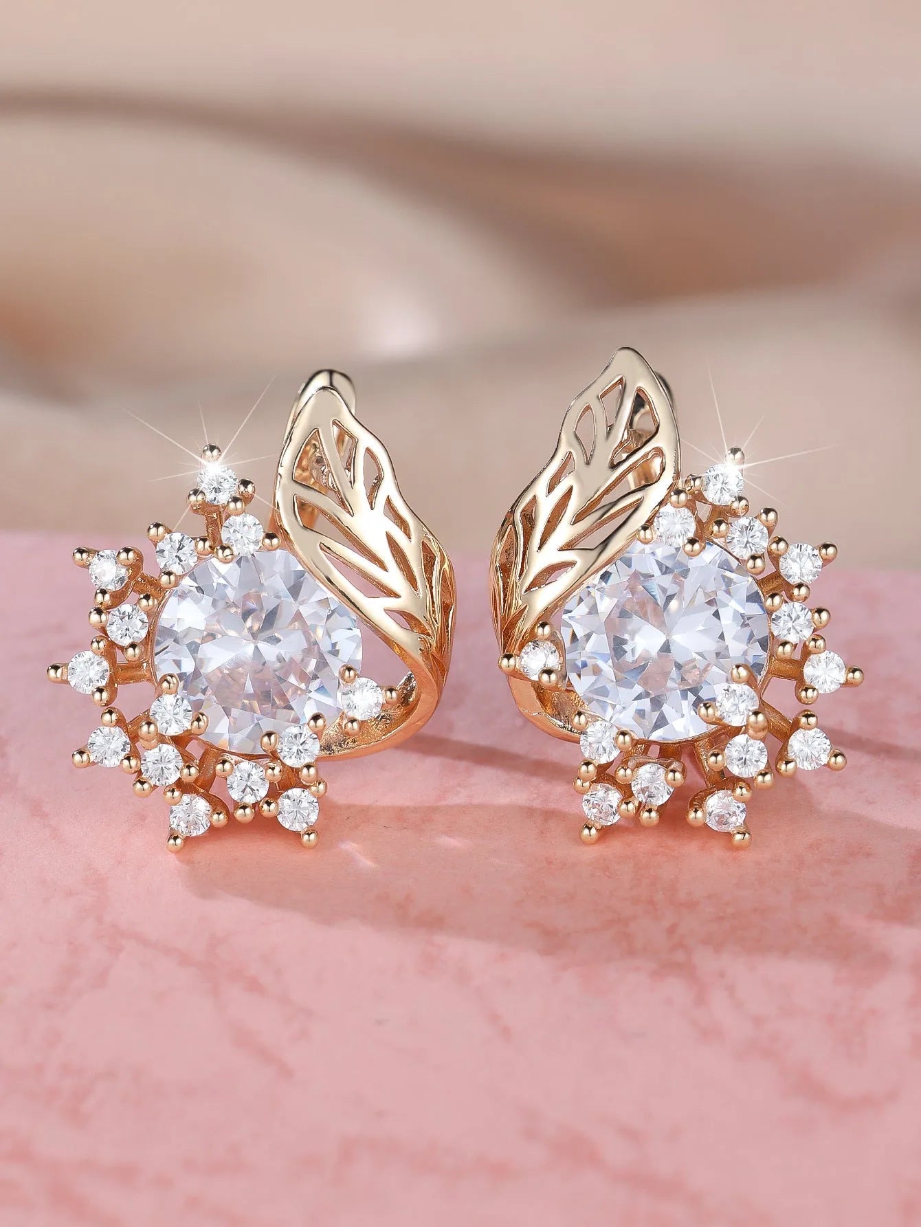Round floral earrings with feather detailing and coloured zircon stones in champagne gold finish