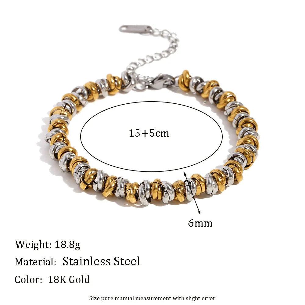 Gold electroplated women's jewellery set with geometric earrings, bracelet, and necklace on stainless steel