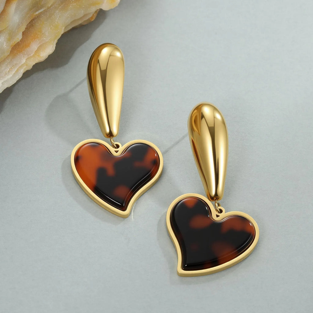 Women's tortoiseshell resin earrings in hawksbill colour with 18K gold plating showing heart and flower geometric designs