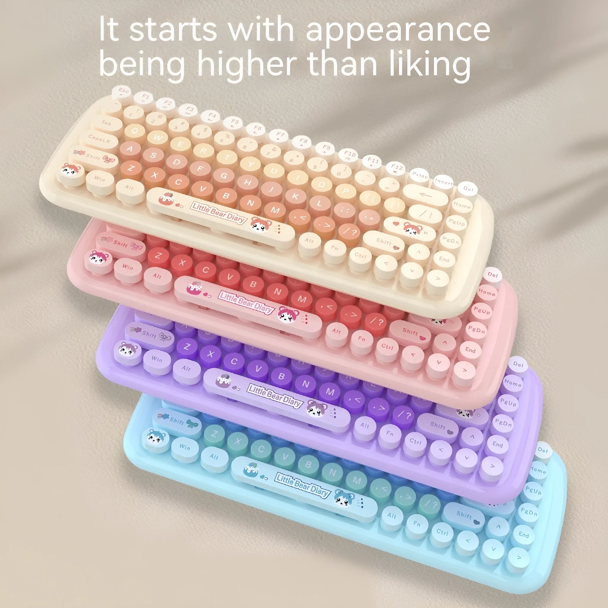 Candy pink wireless keyboard and mouse set on a desk next to a notebook computer.