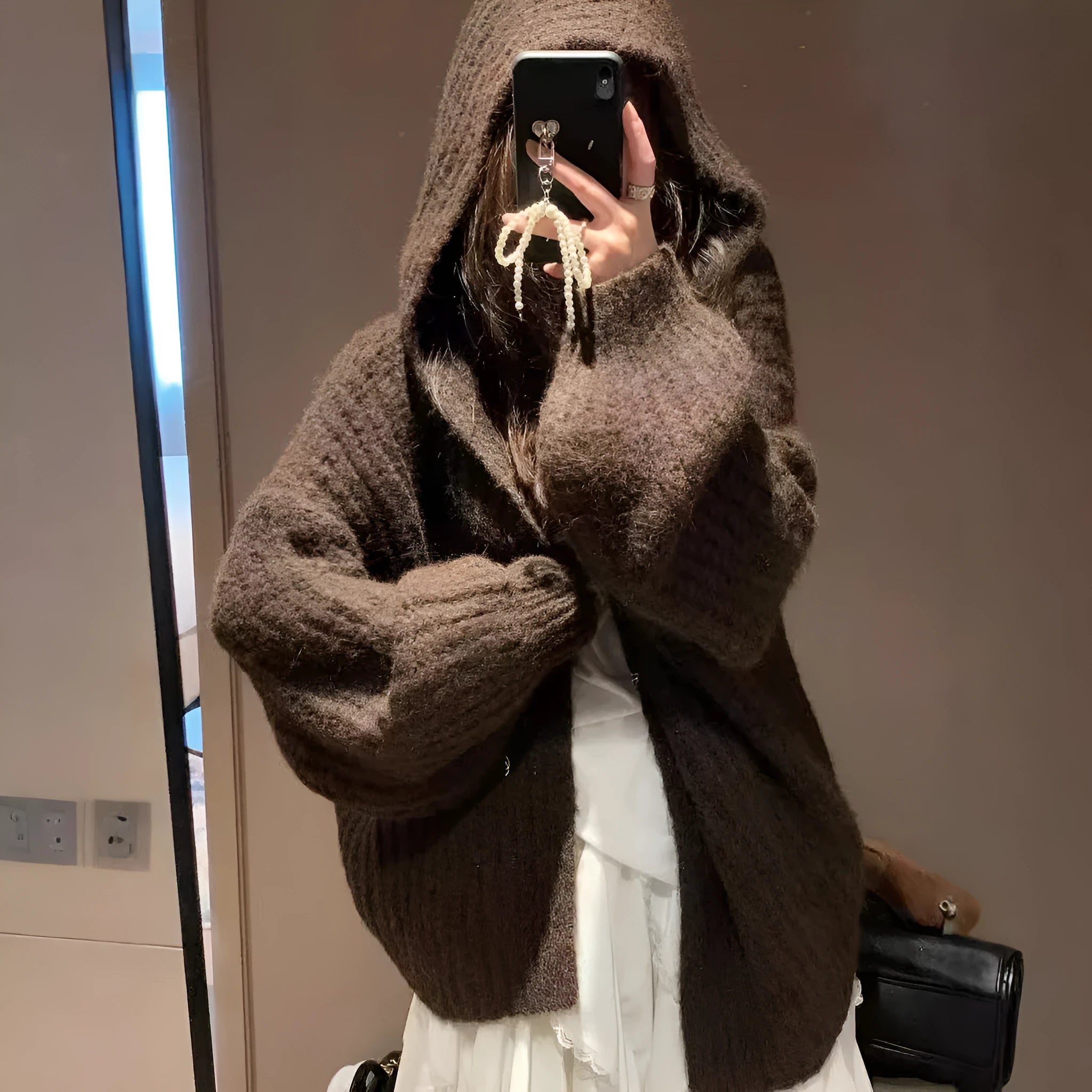 A woman's dark grey hooded cardigan with long sleeves, shown open in a loose fit.