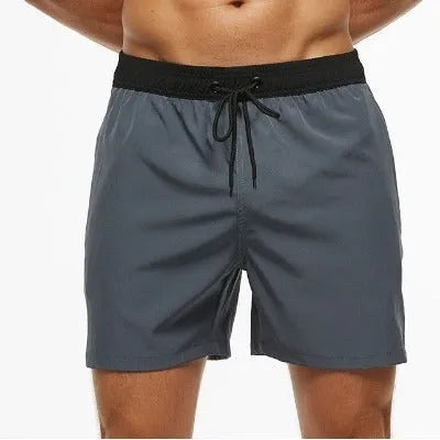 Men's blue running shorts with stitching waistband, zipper pocket, and drawstring for fitness activities