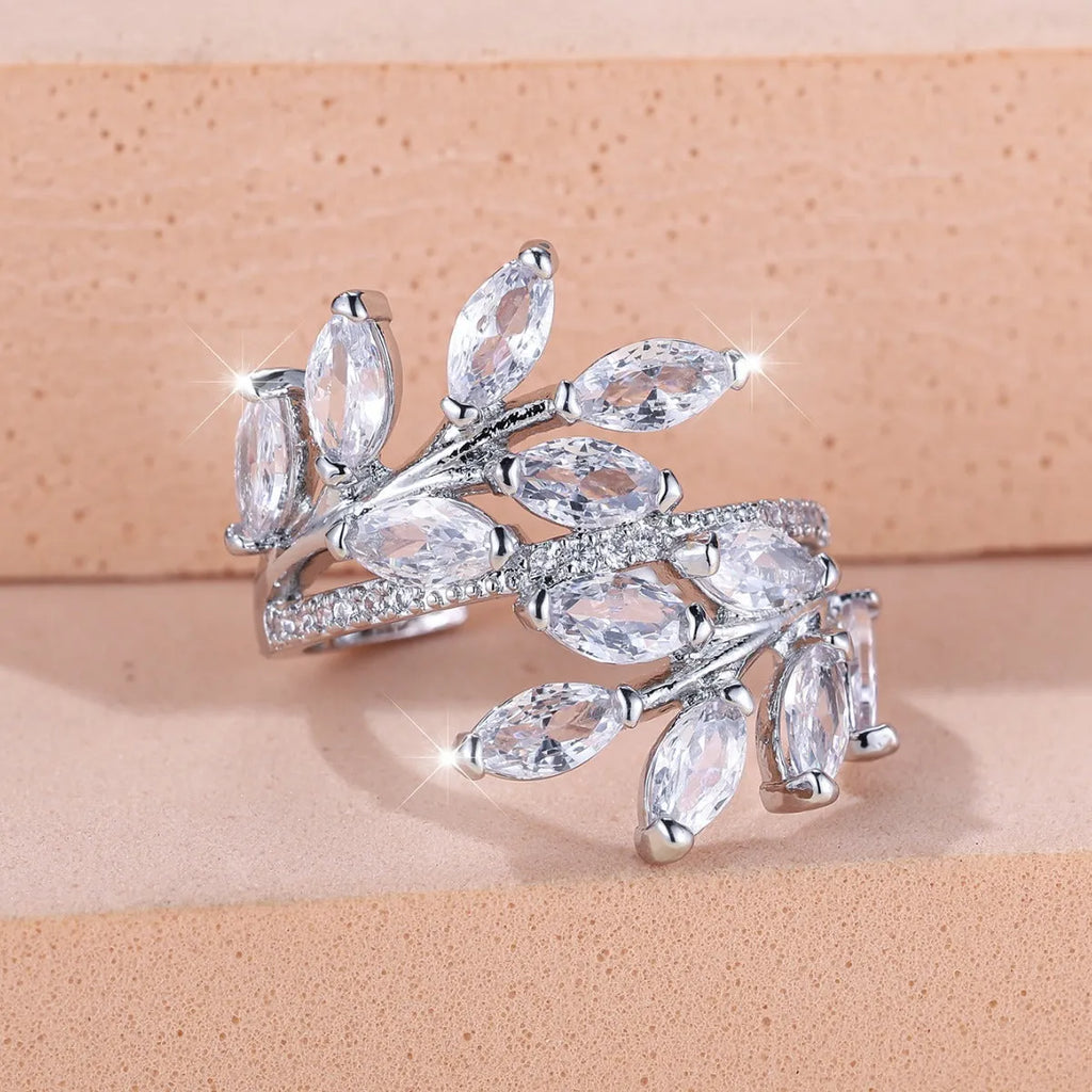 Adjustable horse eye zircon leaf ring in copper on a hand, showing leaf detail and colour options.
