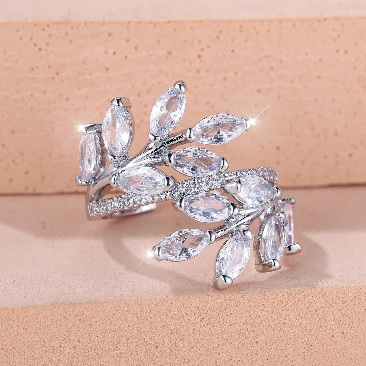 Adjustable horse eye zircon leaf ring in copper on a hand, showing leaf detail and colour options.