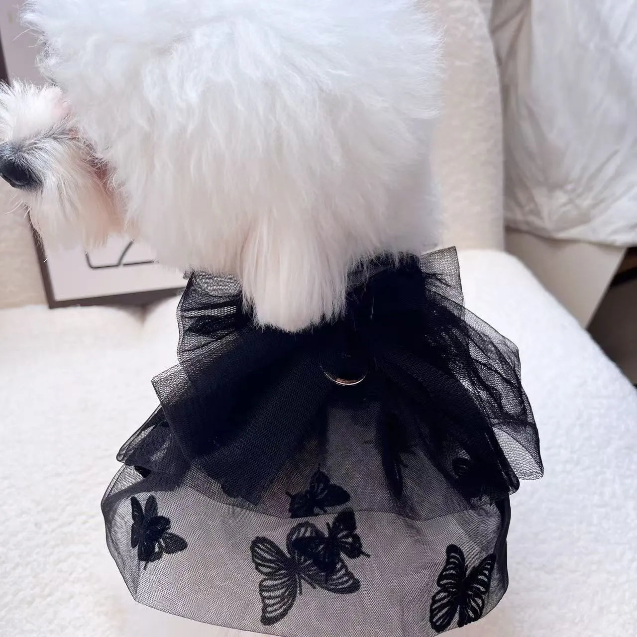 Black polyester tulle princess skirt costume for a small dog or cat on a mannequin, showing the gauzy fabric.