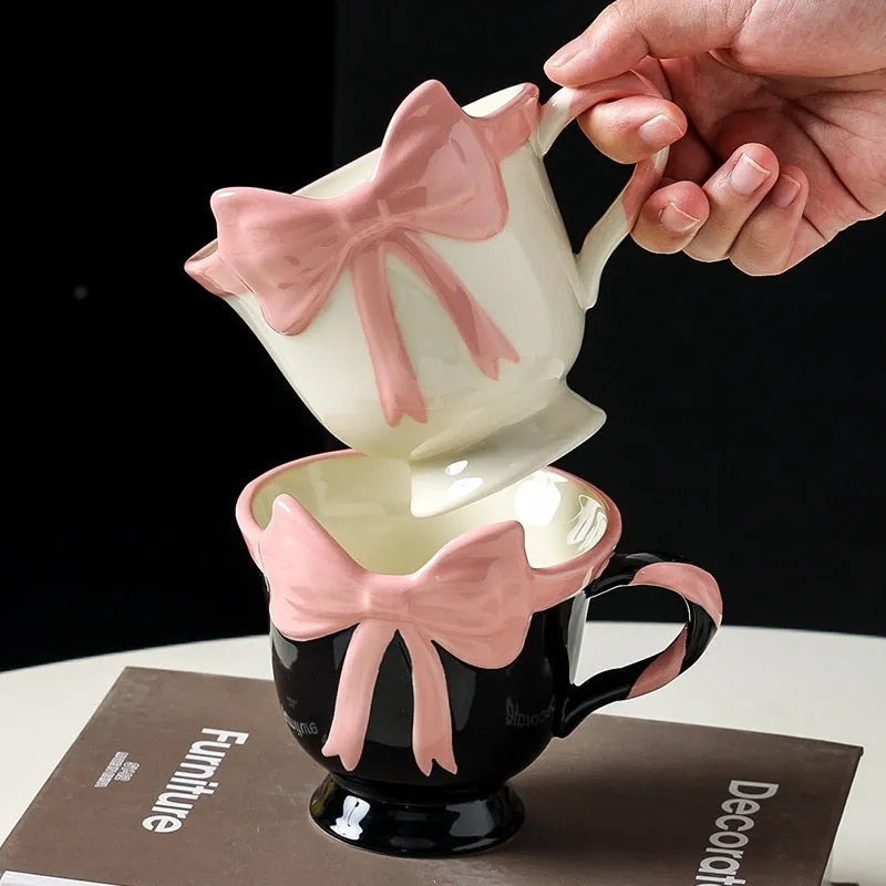 Ceramic mug with bow and heart design in white powder or black pink colours