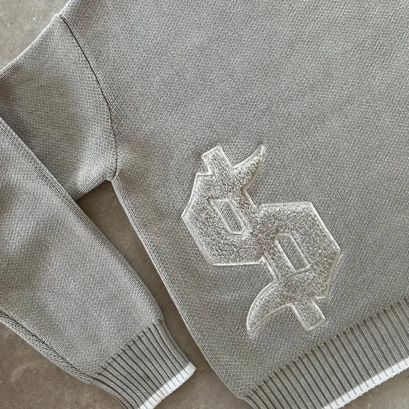 Grey loose-fitting jacquard pattern knitwear coat with long sleeves on hanger