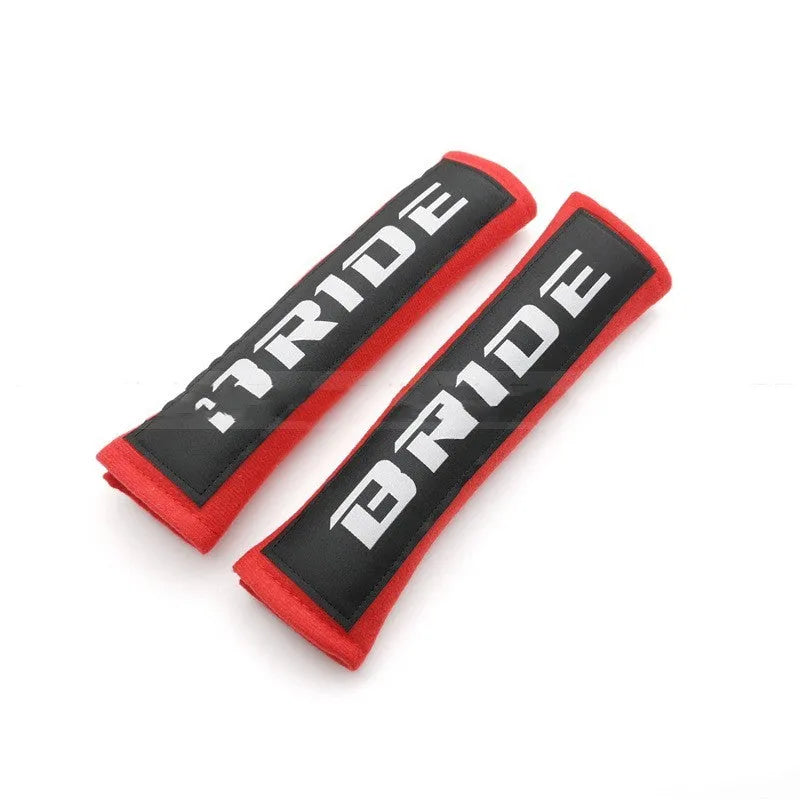 Pair of black car seat belt shoulder pads with embroidery, showing dimensions.