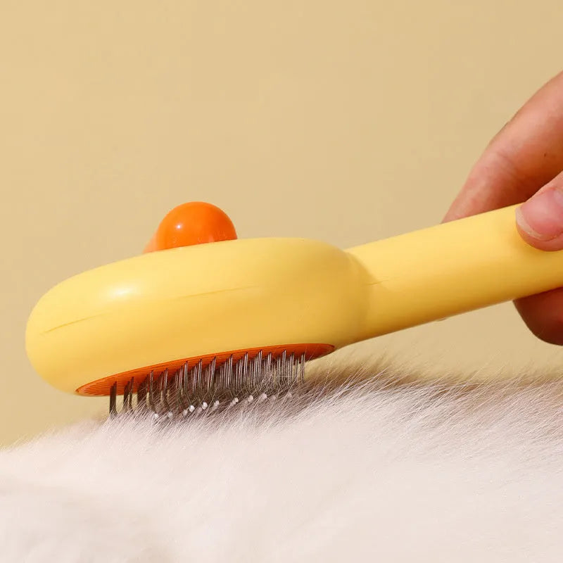 Small yellow duck-shaped pet grooming comb with open section design for cat and dog hair removal