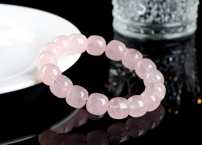 Pink crystal barrel bead bracelet with geometric design for men and women.