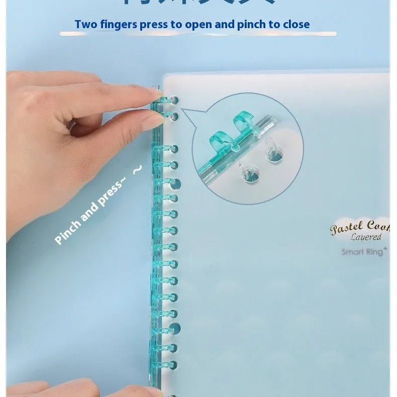 Refillable loose-leaf spiral notebook with PP cover open, showing raw wood pulp paper in grid ruling.