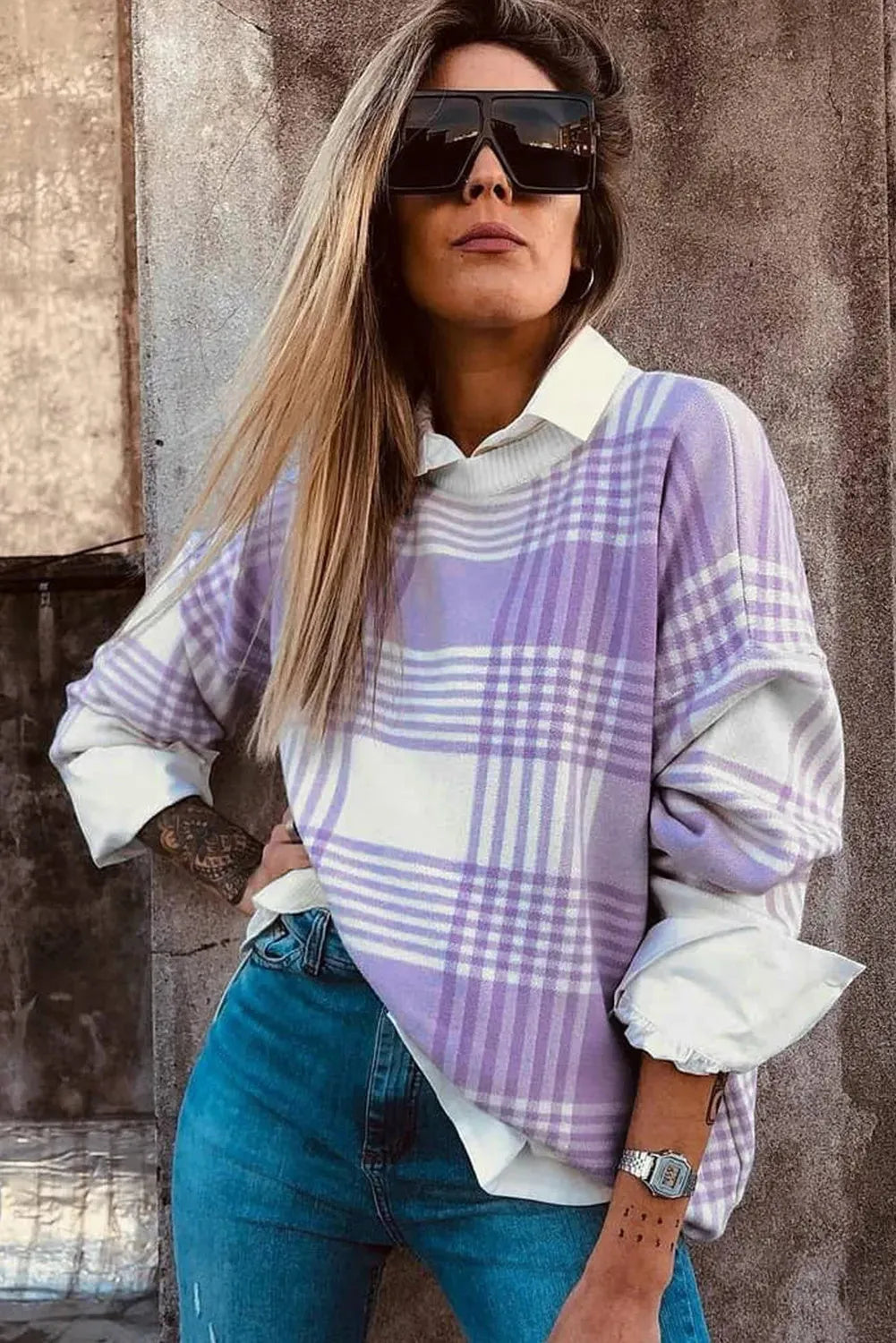 Lilac plaid print loose sweater with ribbed cuffs and hem on a hanger