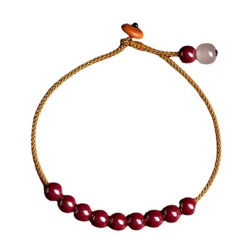 Hand-woven raw ore cinnabar bracelet with Hetian jade accents in a geometric design.