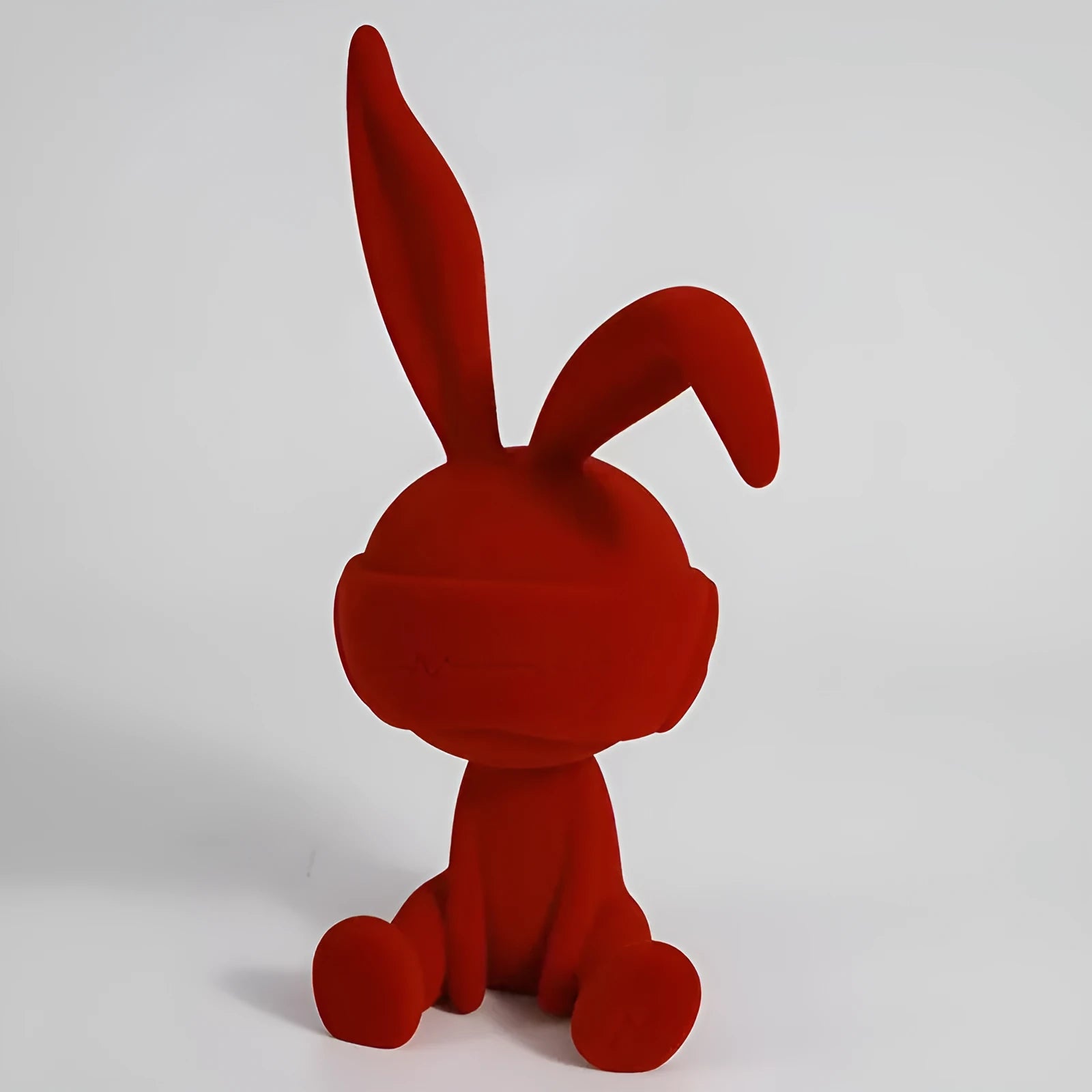 Small resin rabbit table ornament with a suede blindfold, shown in green, blue, and red colour options.
