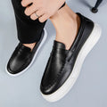 Men's white PU leather slip-on loafers with round toe on a solid background.