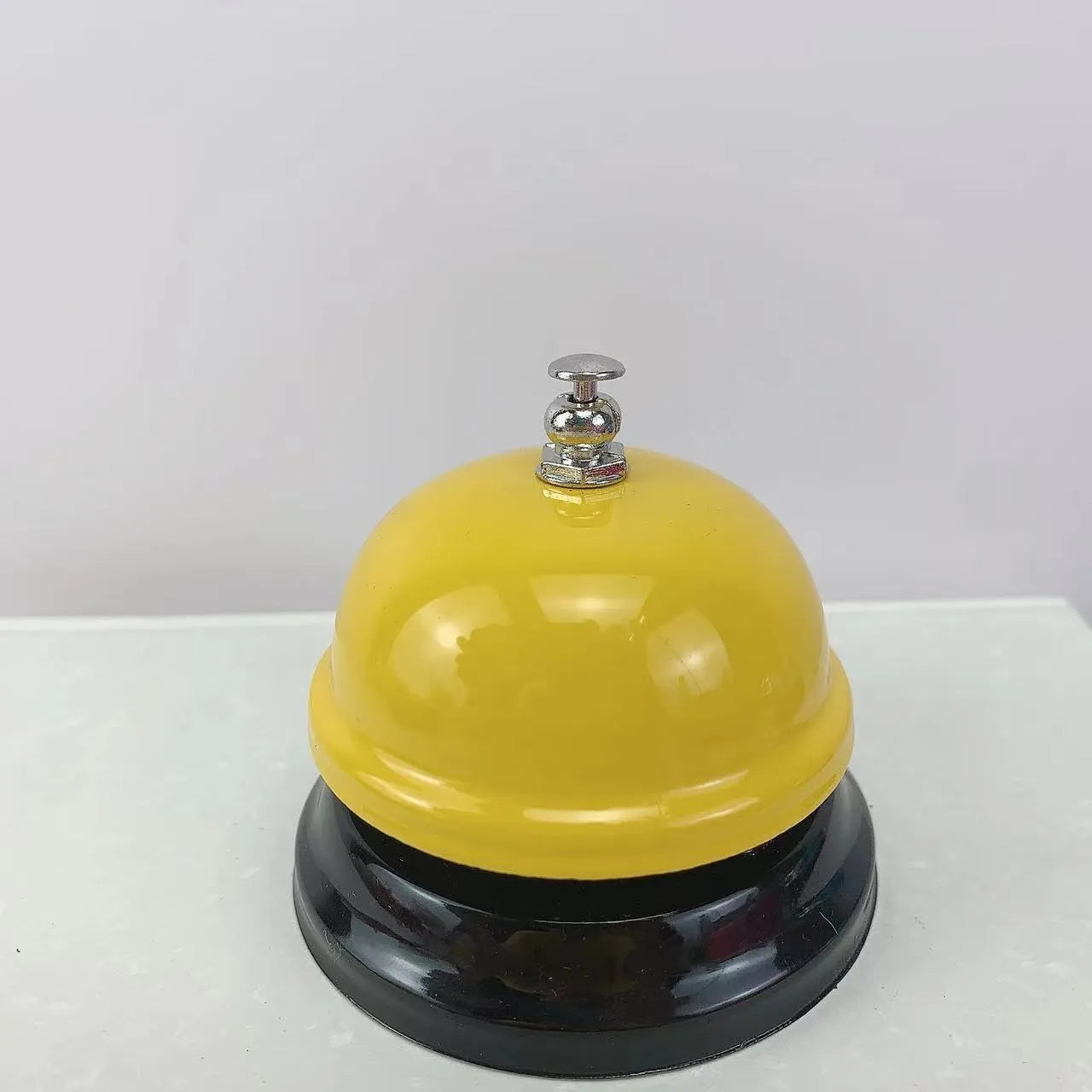 Handheld iron game bell in one of ten colours like red, blue, or green tea, for classroom or restaurant use.
