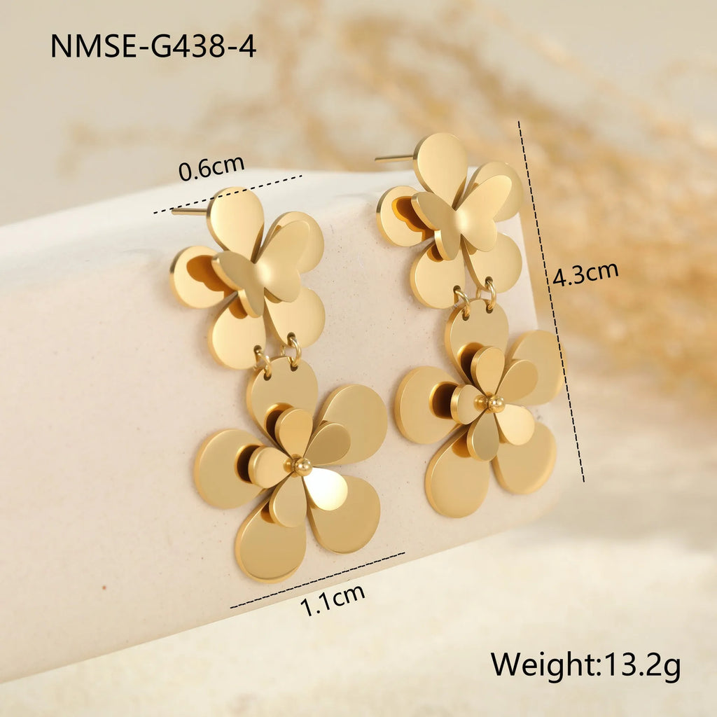 Women's stainless steel earrings with 18K gold electroplated finish featuring floral butterfly and geometric zodiac design