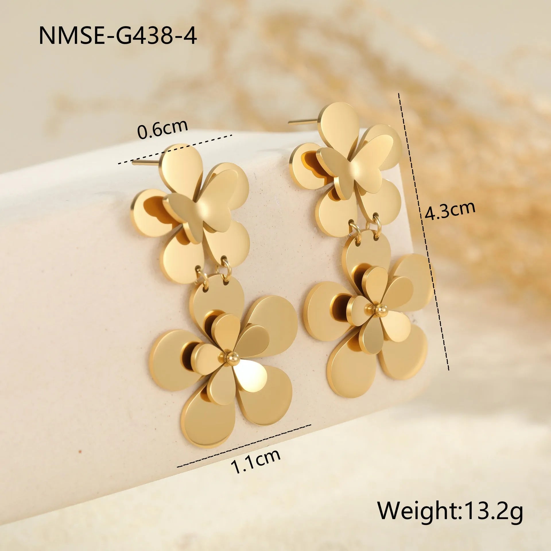 Women's stainless steel earrings with 18K gold electroplated finish featuring floral butterfly and geometric zodiac design