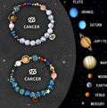 Set of two natural stone beaded bracelets featuring zodiac sign designs on a dark background