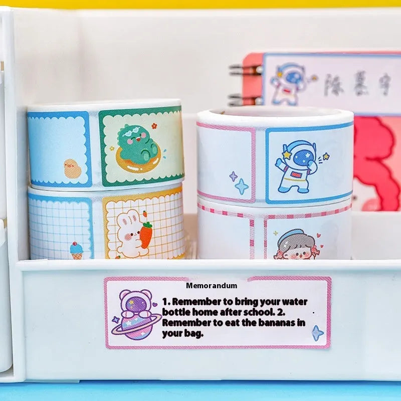 Roll of cartoon adhesive name tape stickers showing Dinosaur, Astronaut, Rabbit, and Girl designs.