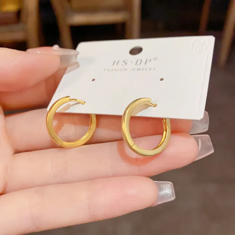 Women's geometric ear clips with round eyelet design in gold plating on copper