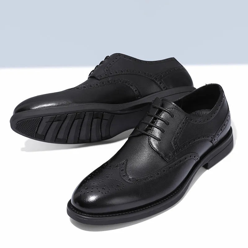 Men's classic black and brown brogue leather shoes with wingtip design on a white background.