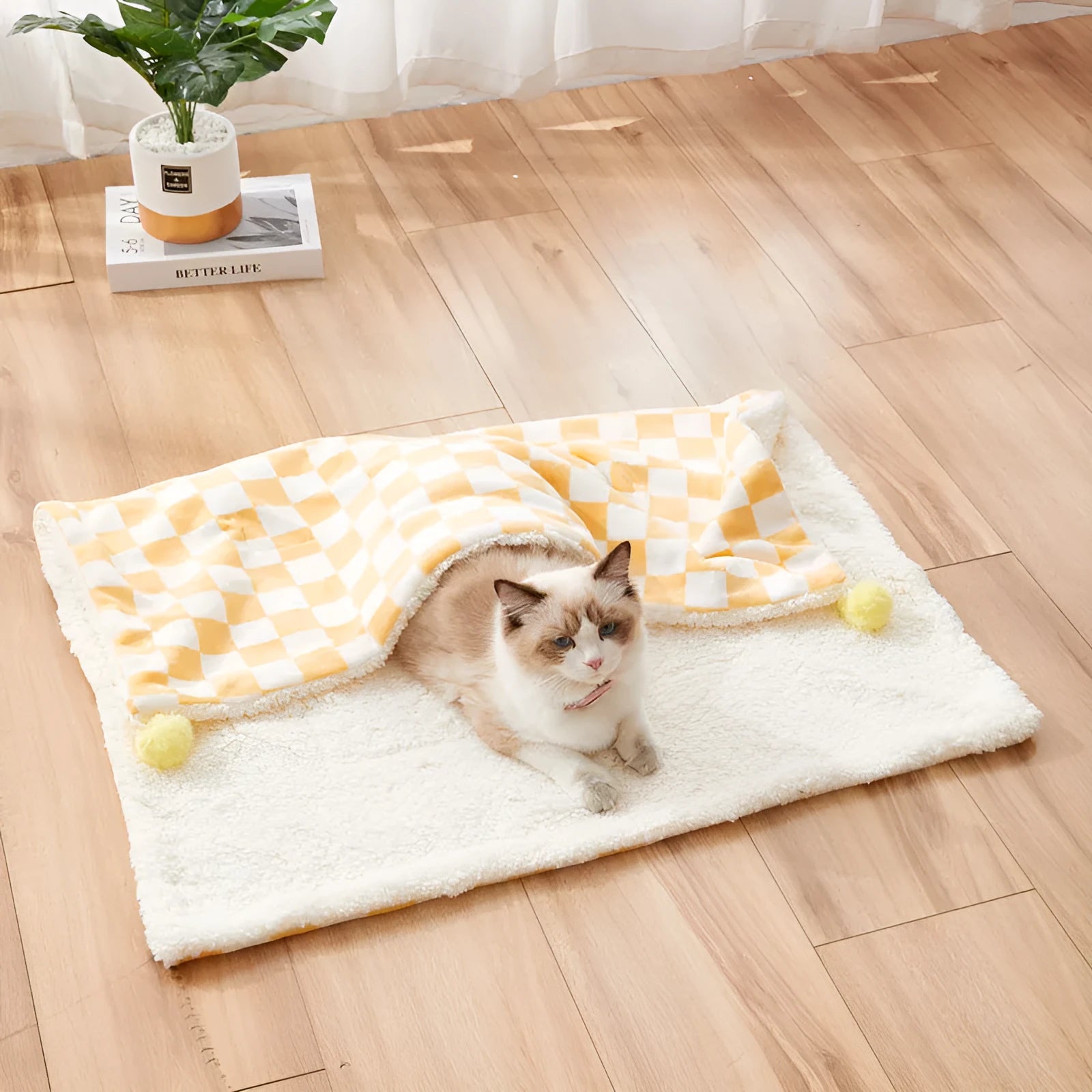 Plush pet blanket with plaid pattern and decorative fur ball in green colour