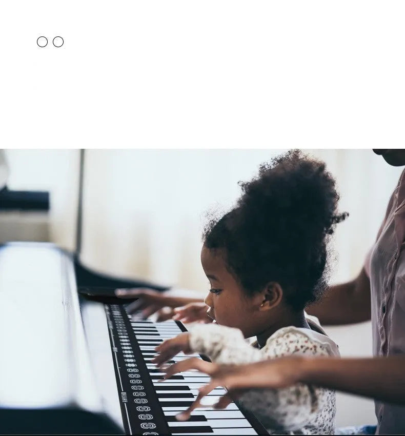 Gloss black portable folding electronic keyboard with 49 silicone keys, unfolded next to its compact folded size.