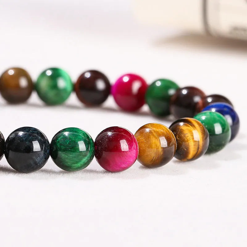 A colourful natural Tiger Eye beaded bracelet showing round beads on a string.