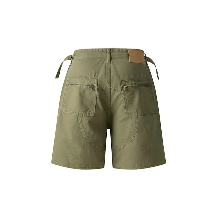 Man wearing grey retro loose-fit washed cotton workwear shorts with a half elastic waistband.