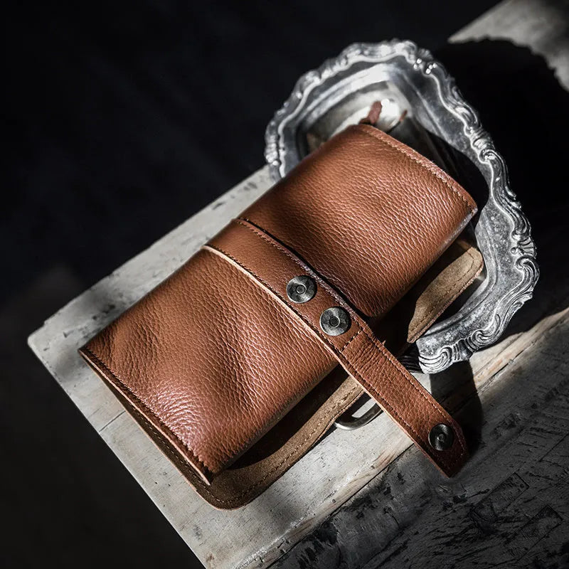 Handmade leather vintage wallet in black or dark brown with tape extraction closure showing 20cm length