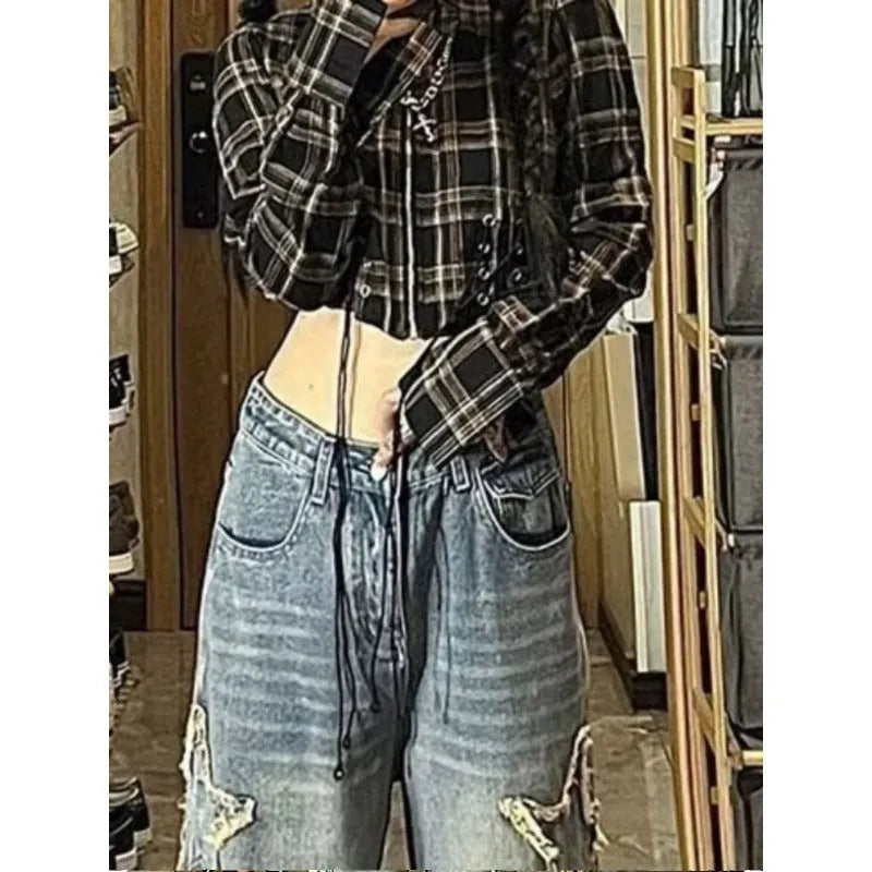 Blue high-waisted wide-leg denim trousers on a hanger, showing the straight-leg cut and front view.
