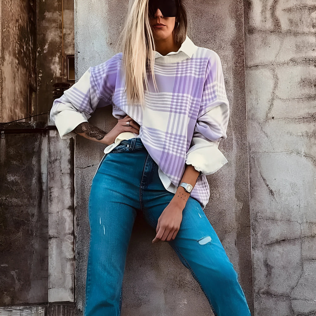Lilac plaid print loose sweater with ribbed cuffs and hem on a hanger