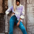 Lilac plaid print loose sweater with ribbed cuffs and hem on a hanger