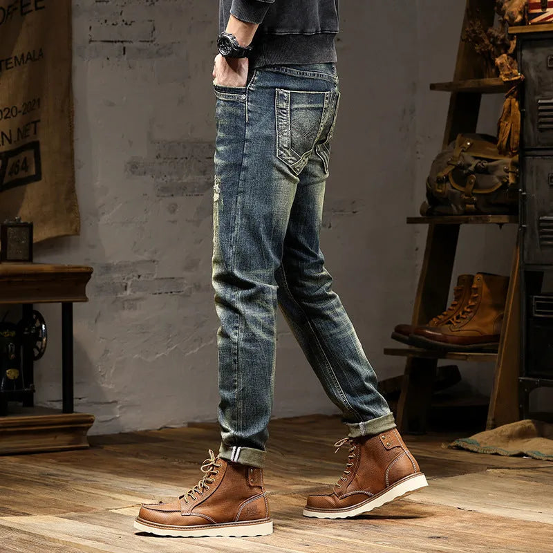 Men's skinny fit stretch denim jeans in a retro colour with a zip fly, laid flat.