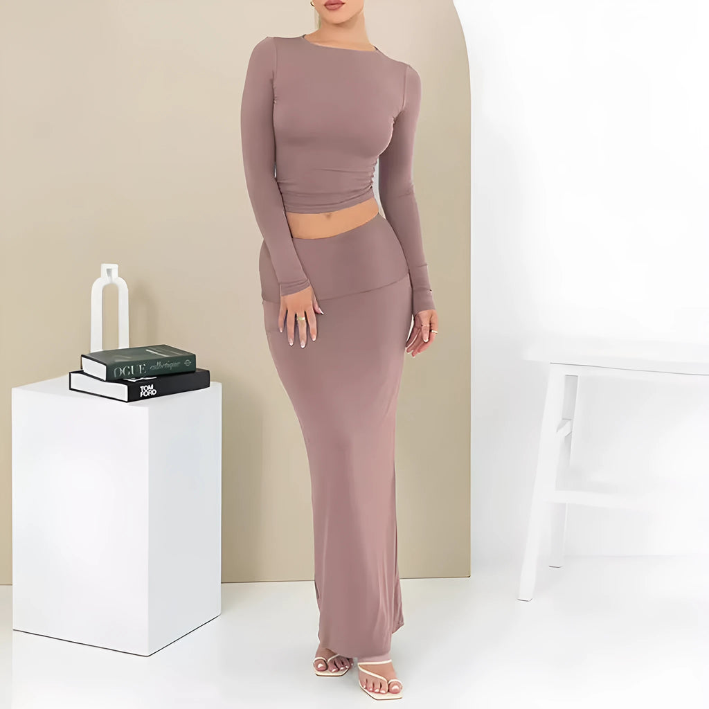 Women's black slim fit two-piece suit set with three-quarter sleeve top and long skirt on a model.