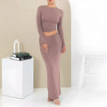 Women's black slim fit two-piece suit set with three-quarter sleeve top and long skirt on a model.