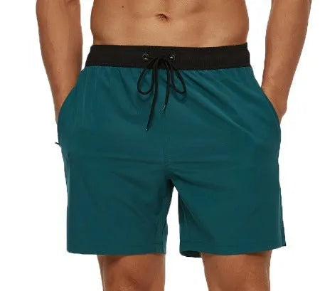 Men's blue running shorts with stitching waistband, zipper pocket, and drawstring for fitness activities