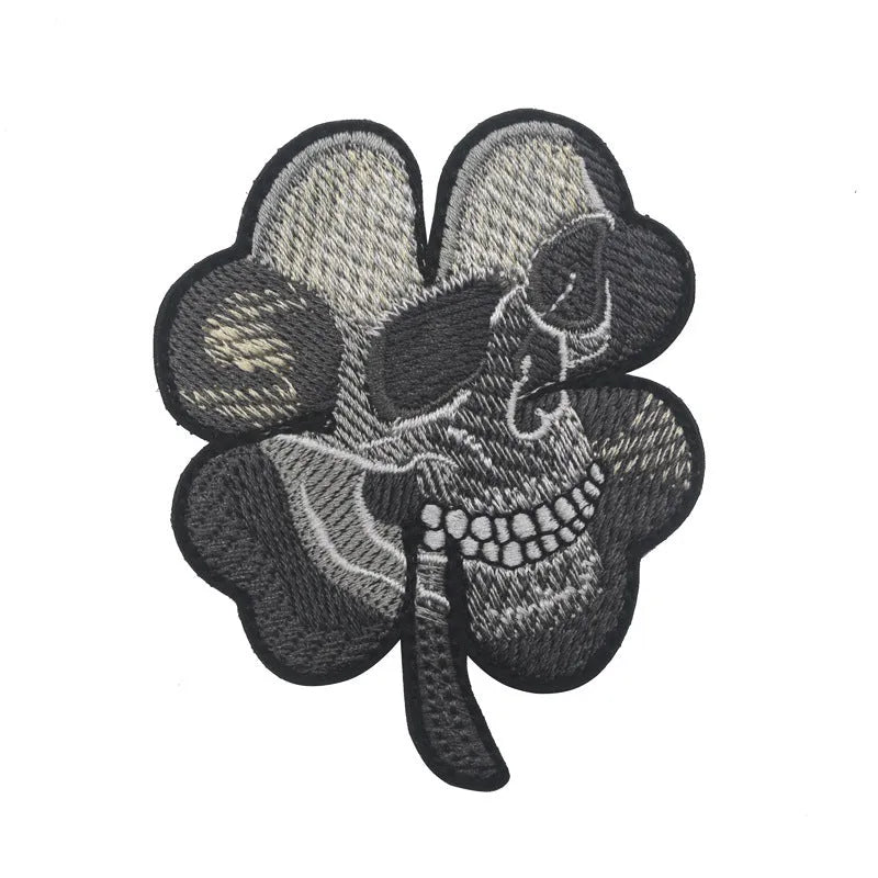 Outdoor embroidered fabric badge with Velcro strip backing on a green clover design.