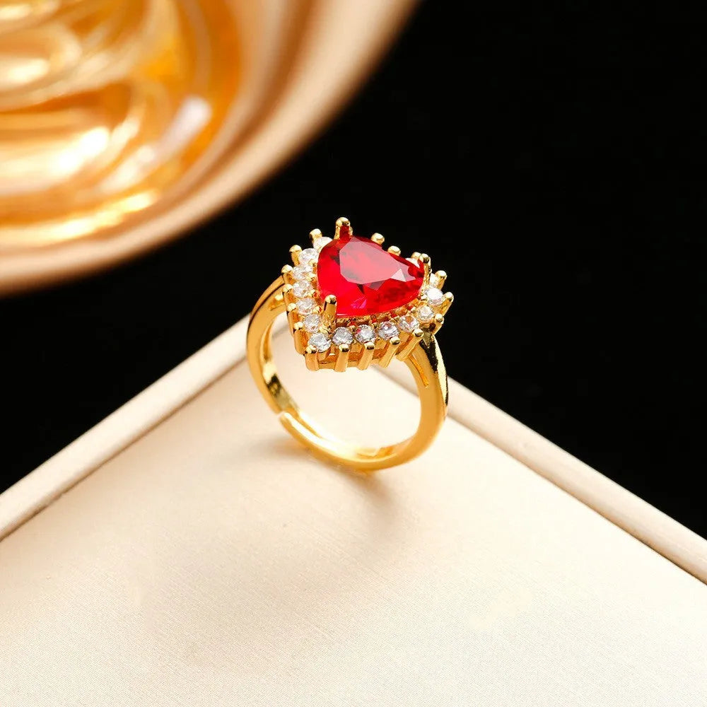 Gold-red titanium steel necklace and earrings set with heart-shaped flower pendant and gemstone detail.