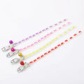 Luminous adjustable cat collar with bell in silicone and metal, showing paw print design for night visibility.