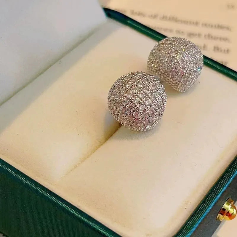 Gold and white geometric drop earrings with sparkling diamond-cut bean spheres.