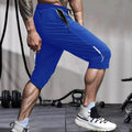 Man wearing grey cropped nylon sports pants with straight leg for summer beach activity