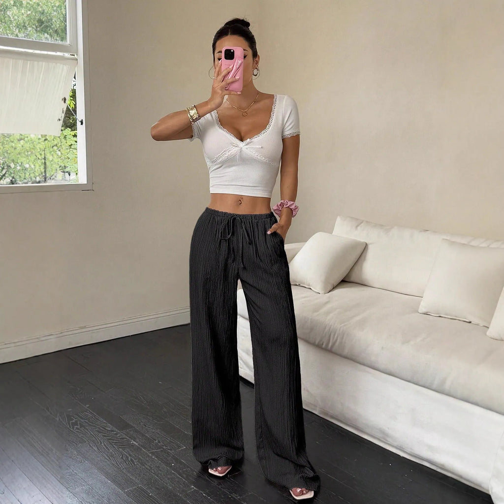 Women's wide-leg trousers with lace-up waist detail in black and pink colour options