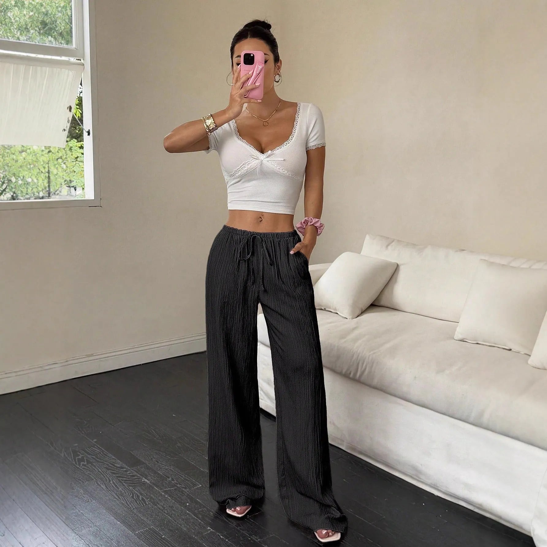 Women's wide-leg trousers with lace-up waist detail in black and pink colour options