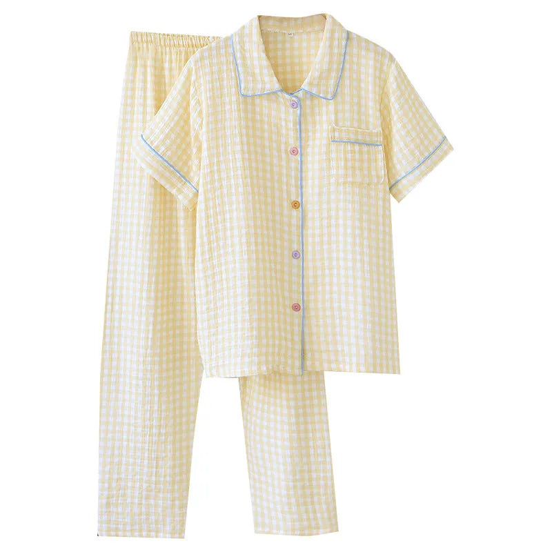 Women's loose-fit yellow plaid cotton gauze short-sleeve top and trouser set on a hanger.