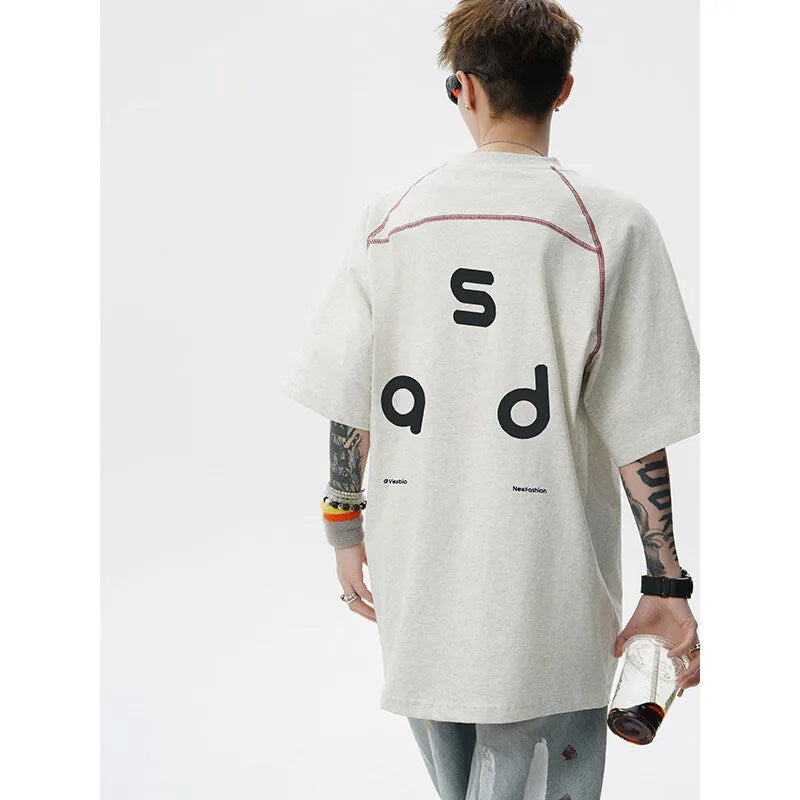 Loose fit black cotton t-shirt with a white letter print design on the front.