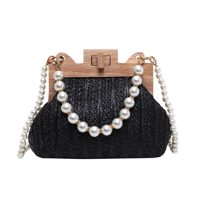 Women's straw woven shoulder bag with pearl chain strap in horizontal square shape showing internal organisers